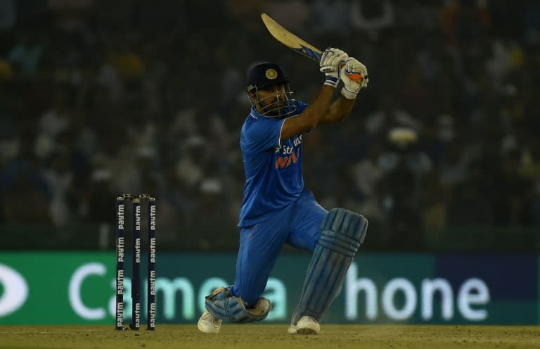 India's captain Mahendra Singh Dhoni plays a shot in Mohali on October 23, 2016