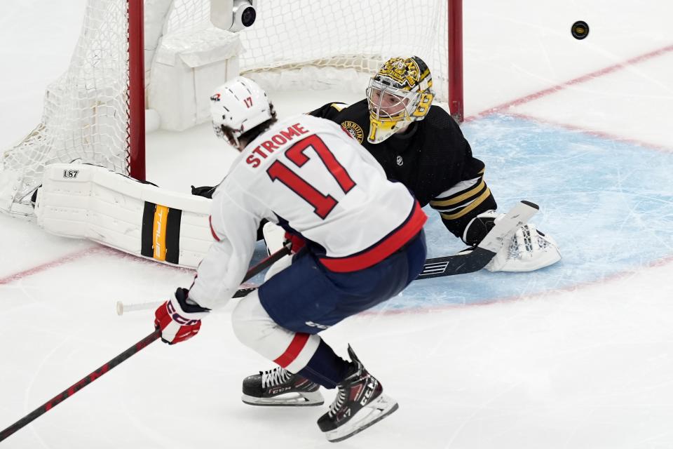 The puck rebounds out of the net after the goal by Washington Capitals' Dylan Strome (17) on Boston Bruins' Jeremy Swayman (1) during the third period of an NHL hockey game, Saturday, Feb. 10, 2024, in Boston. (AP Photo/Michael Dwyer)