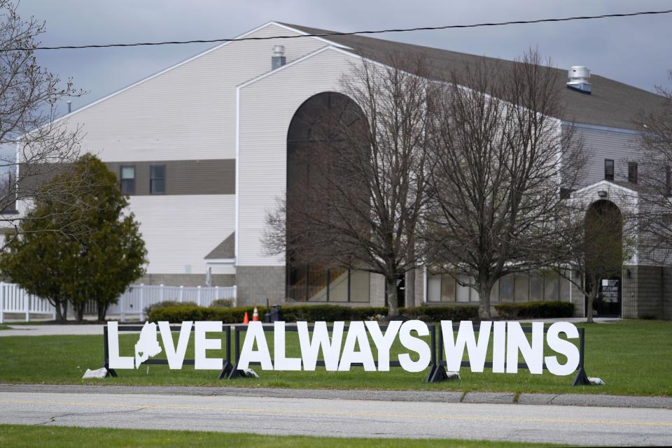 A sign of positivity decorates the lawn at Just In Time Recreation, Wednesday, May 1, 2024, in Lewiston, Maine. The bowling alley, where eight people were killed in last October's mass shooting, was scheduled to reopen Friday, May 3. (AP Photo/Robert F. Bukaty)