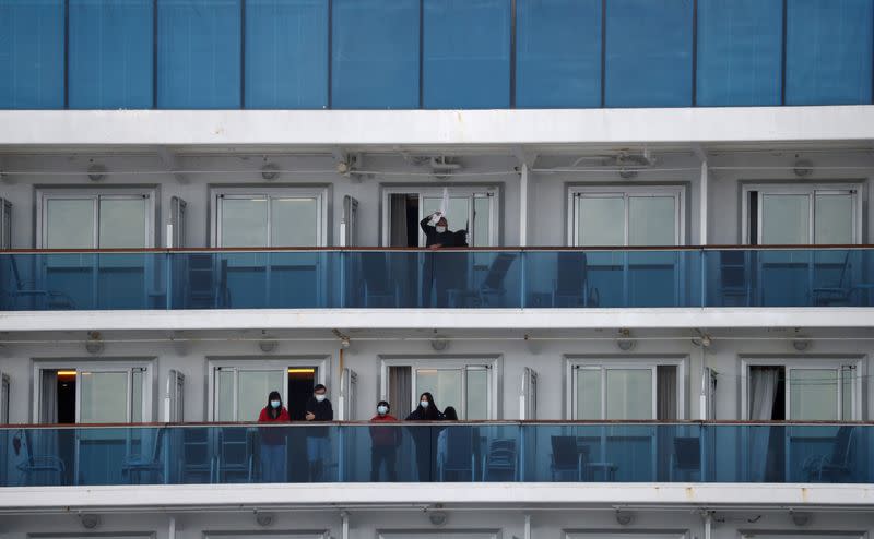 Passengers stand on the cruise ship Diamond Princess at Daikoku Pier Cruise Terminal in Yokohama