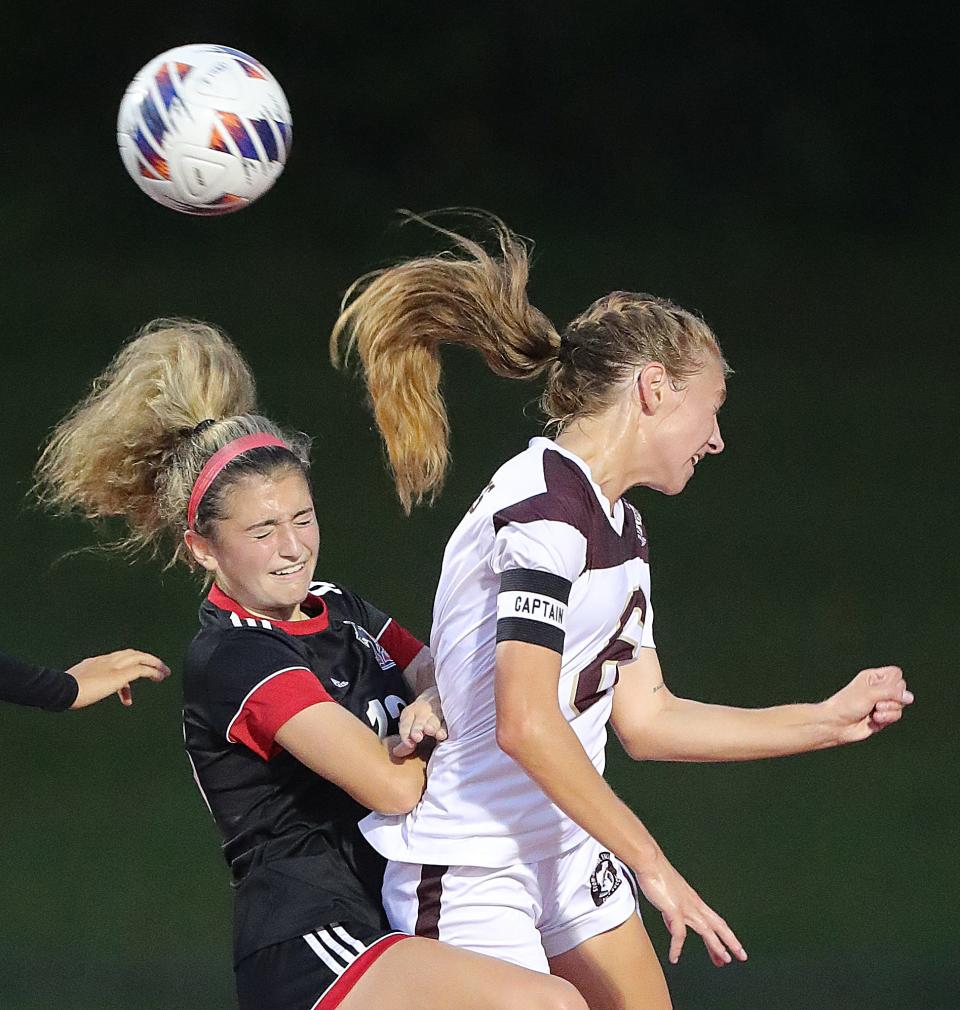 Kent's Abby Carbone, left, and Stow's Kailey Hobart go up after a head ball on a first half Bulldog corner kick on Monday, Sept. 19, 2022 in Kent.