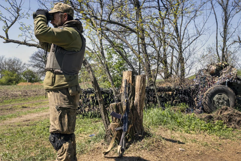 A Ukrainian soldier at a short-range artillery position in the Kherson region of southern Ukraine monitors Russian movements in the distance on Friday, May 6, 2022.  (David Guttenfelder/The New York Times)