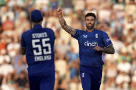 England's Reece Topley, right, celebrates the dismissal of New Zealand's Tom Latham with team mate Ben Stokes during the second one day international cricket match between England and New Zealand, at The Ageas Bowl, Southampton, England, Sunday Sept. 10, 2023. (John Walton/PA via AP)