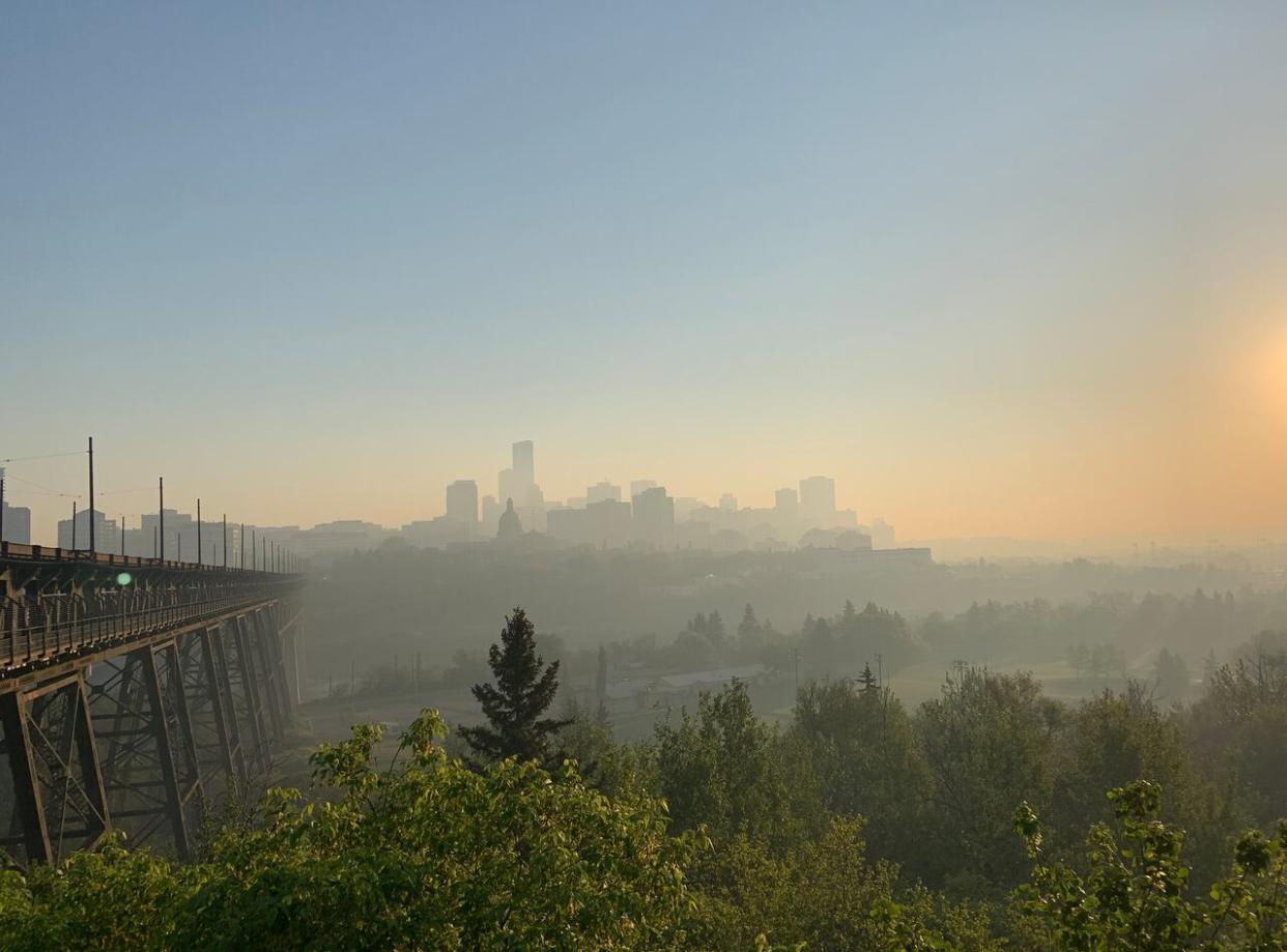 In this photo from May 2023, wildfire smoke creates a hazy Edmonton skyline at sunrise. Edmonton's fire chief says there have been more than 145 wildfires in Edmonton so far this year. (Sylvain Bascaron/Radio-Canada - image credit)