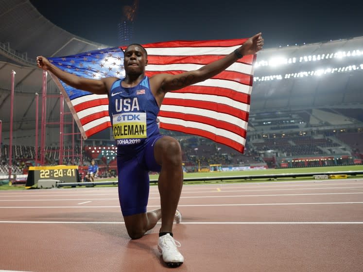 FILE - In this Sept. 28, 2019, file photo, Christian Coleman, of the United States, celebrates winning the gold medal in the men's 100 meter final race at the World Athletics Championships in Doha, Qatar. Men's 100-meter world champion Christian Coleman was banned for two years on Tuesday, Oct. 27, 2020, for missing three doping control tests. Track and field's Athletics Integrity Unit said Coleman will be banned until May 2022, forcing him to miss the Tokyo Olympics next year. (AP Photo/David J. Phillip)