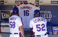 <p>Yoenis Cespedes #52 of the New York Mets and Josh Smoker #58 of the New York Mets hang a jersey for Jose Fernandez of the Miami Marlins in their dugout prior to taking on the Philadelphia Phillies at Citi Field on September 25, 2016 in the Flushing neighborhood of the Queens borough of New York City. Fernandez died earlier in the day in a boating accident. (Photo by Adam Hunger/Getty Images) </p>