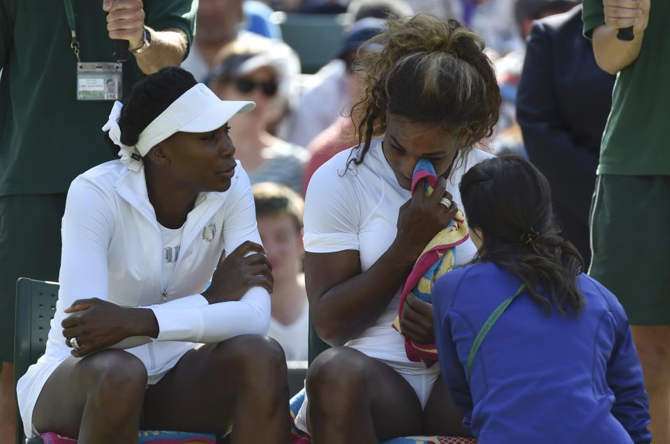 Serena Williams of the U.S. appears unwell before retiring from her women's doubles tennis match with Venus Williams of the U.S. against Kristina Barrois of Germany and Stefanie Voegele of Switzerland at the Wimbledon Tennis Championships, in London