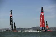 Emirates Team New Zealand (R) sails ahead of Oracle Team USA during Race 12 of the 34th America's Cup yacht sailing race in San Francisco, California September 18, 2013. REUTERS/Robert Galbraith