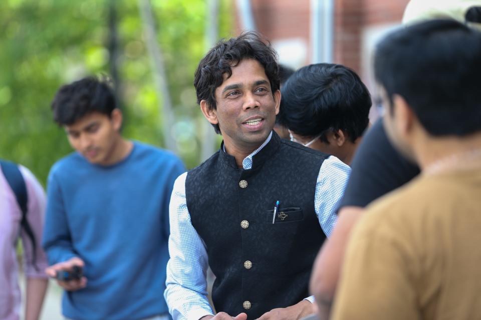 Kshitij Mall, a post-doctoral research associate at Purdue University, speaks with other protesters as they begin to organize to protest against the owner of the Blue Nile Restaurant, on Friday, May 5, 2023, in West Lafayette, Ind.