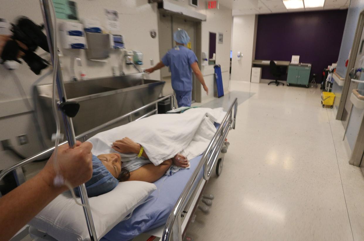 Patient Kaori Noguchi is wheeled to the operating room ofWomen’s College Hospital in Toronto. (Toronto Star via Getty Images)