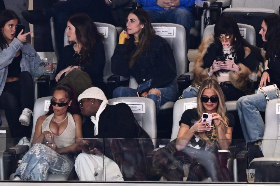 La La Anthony, left, Khloe Kardashian, right, and Winnie Harlow, top, second right, attend the Super Bowl.