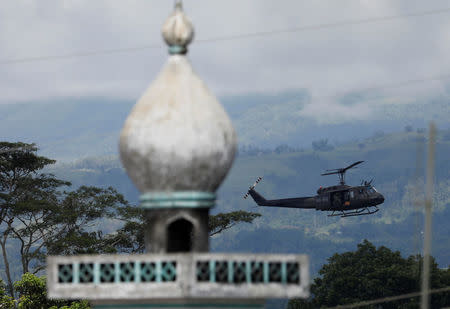 A military helicopter flies past a mosque in Marawi City in southern Philippines May 28, 2017. REUTERS/Erik De Castro