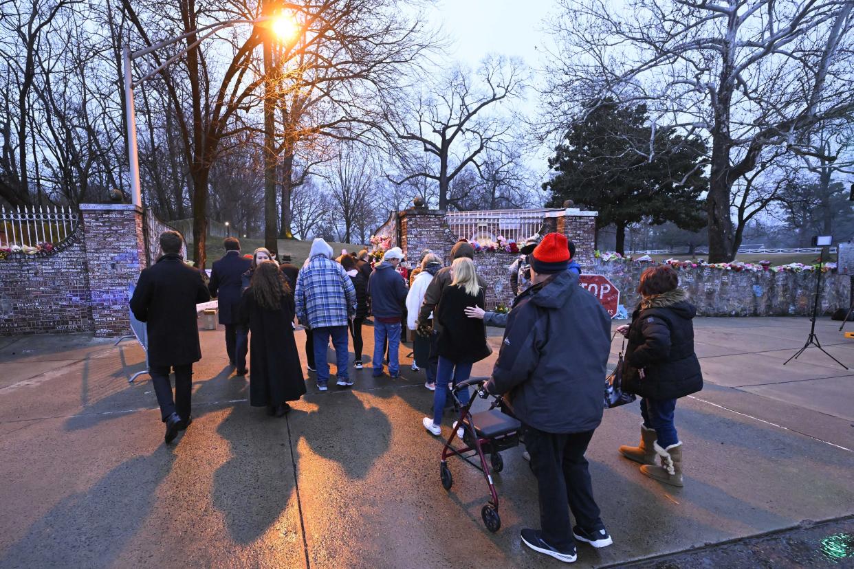 Fans enter Graceland for a memorial service for Lisa Marie Presley Sunday, Jan. 22, 2023, in Memphis, Tenn. She died Jan. 12 after being hospitalized for a medical emergency and was buried on the property next to her son Benjamin Keough, and near her father Elvis Presley and his two parents. (AP Photo/John Amis)