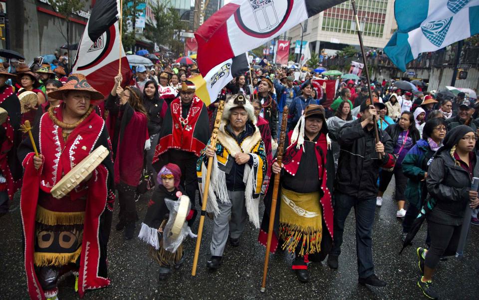 First Nations' people in traditional dress take part in a Truth and Reconciliation march in Vancouver