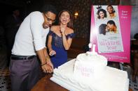 Tyler James Williams and Sarah Hyland crack up and cut cake on Thursday at the Los Angeles premiere of their film <em>The Wedding Year.</em>