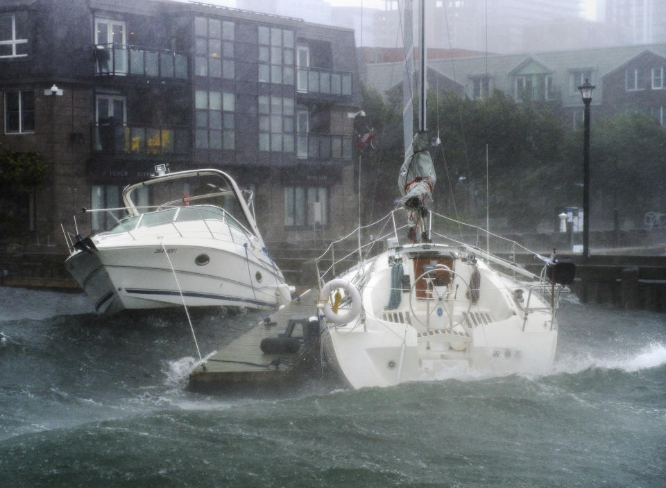 Waves crash into boats long the waterfront in Halifax, Nova Scotia as hurricane Dorian approaches on Saturday, Sept. 7, 2019. Weather forecasters say Hurricane Dorian is picking up strength as it approaches Canada. (Andrew Vaughan/The Canadian Press via AP)