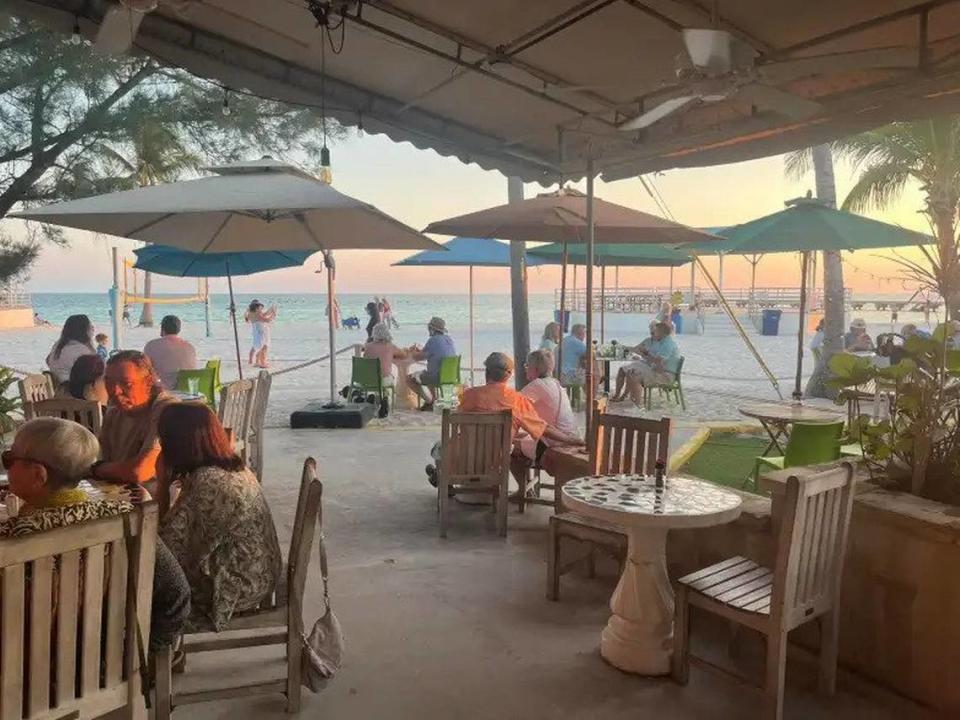 Diners enjoy a waterfront sunset at Salute! on the Beach in Key West, which was just named one of the best beachfront restaurants in Florida.