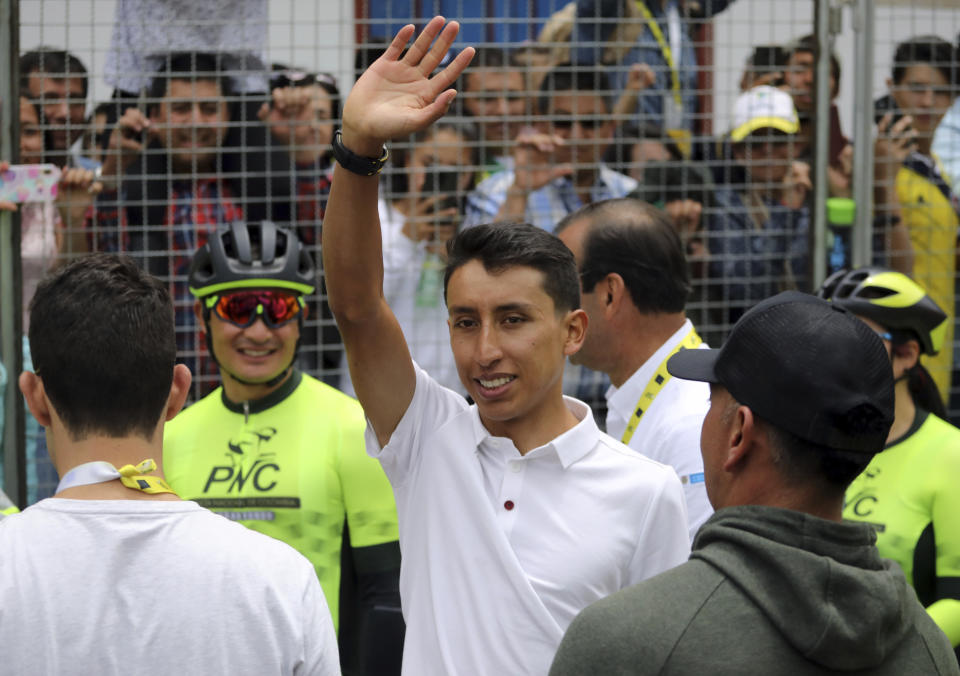 Tour de France winner Egan Bernal waves to the crowd as he is welcomed home to Zipaquira, Colombia, Wednesday, Aug. 7, 2019. Bernal rode into the town's central square on his bike on wearing the Tour de France's iconic yellow jersey. A group of some 3,000 supporters dressed in the same color chanted his name. (AP Photo/Ivan Valencia)