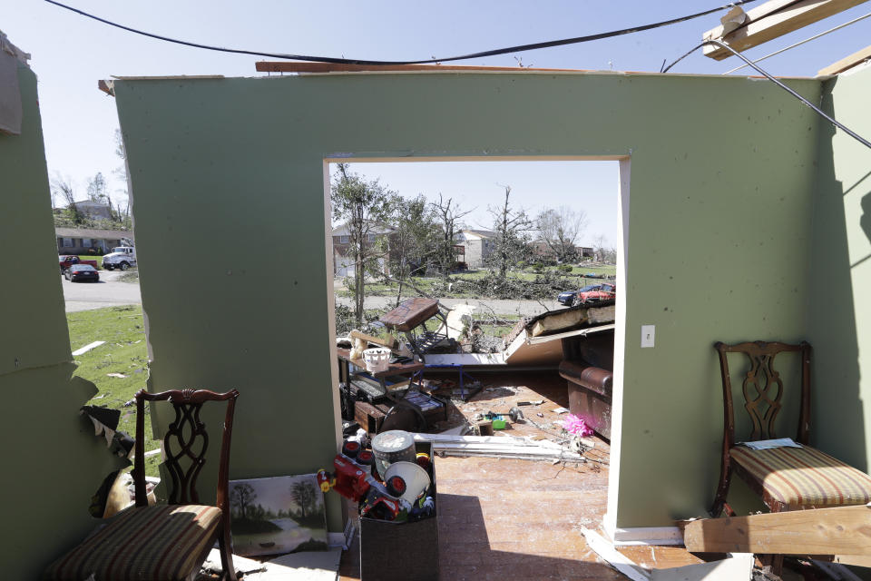 Furniture is scattered through a damaged home Tuesday, April 14, 2020, in Chattanooga, Tenn. Tornadoes went through the area Sunday, April 12. (AP Photo/Mark Humphrey)