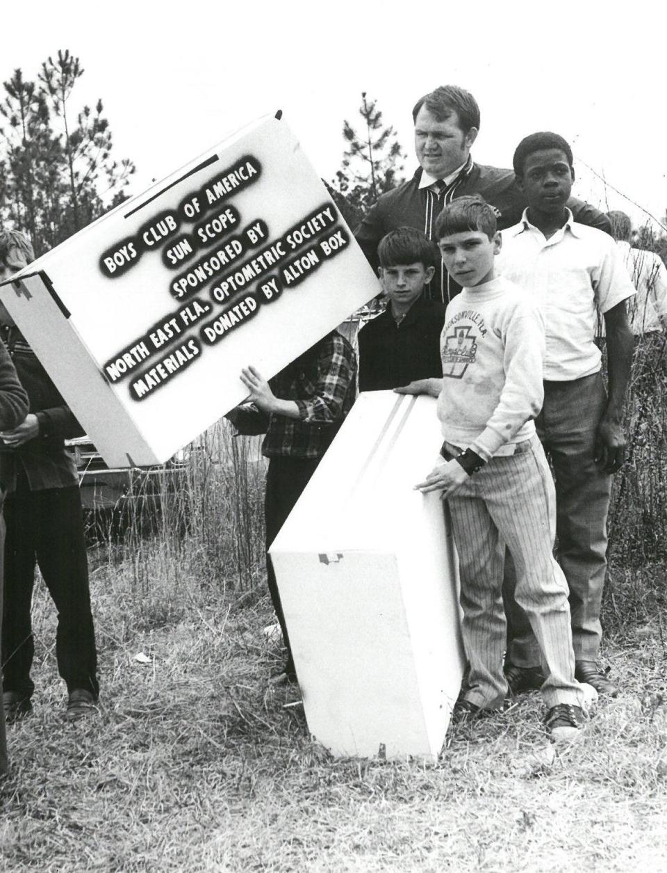 Members of the Boys Club of America crowd around a sun scope in anticipation of the solar eclipse on March 7, 1970.