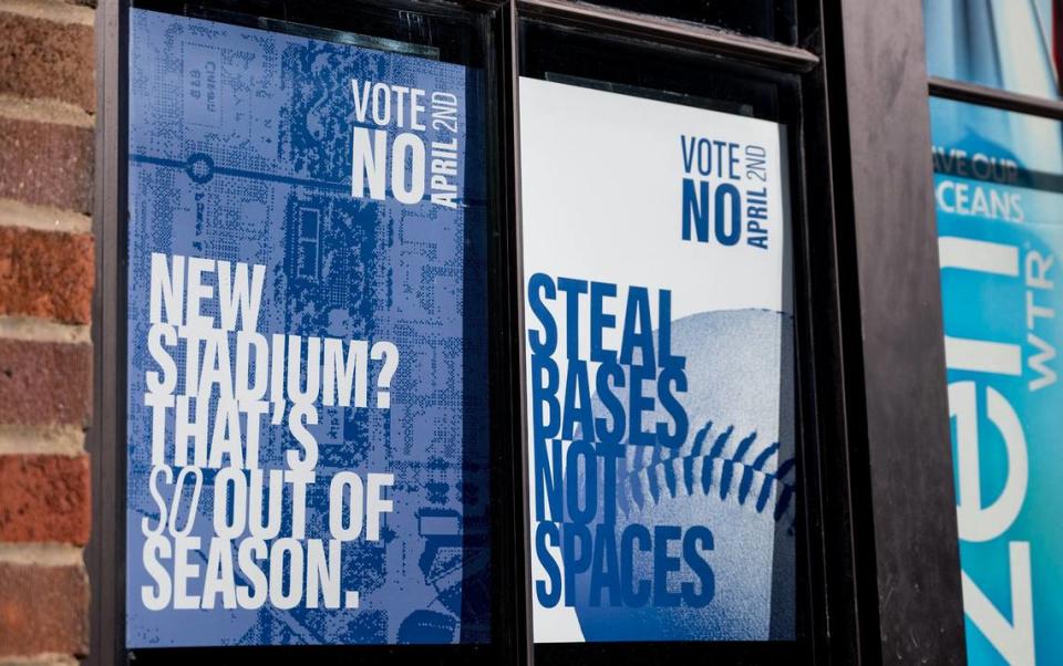 Signs in a Kansas City window urge voters to vote against a 40-year, 3/8th-cent sales tax to pay for a new Royals stadium and improvements to Arrowhead Stadium.
