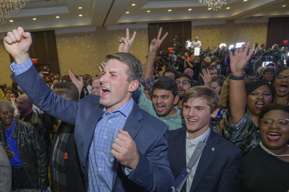 Supporters react as Louisiana Gov. John Bel Edwards arrives to address supporters at his election night watch party in Baton Rouge, La., Saturday, Nov. 16, 2019. (AP Photo/Matthew Hinton)