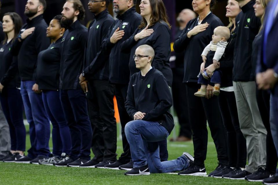 Kelly Holstine kneeling during the national anthem at Monday's college football championship | Kevin C. Cox/Getty