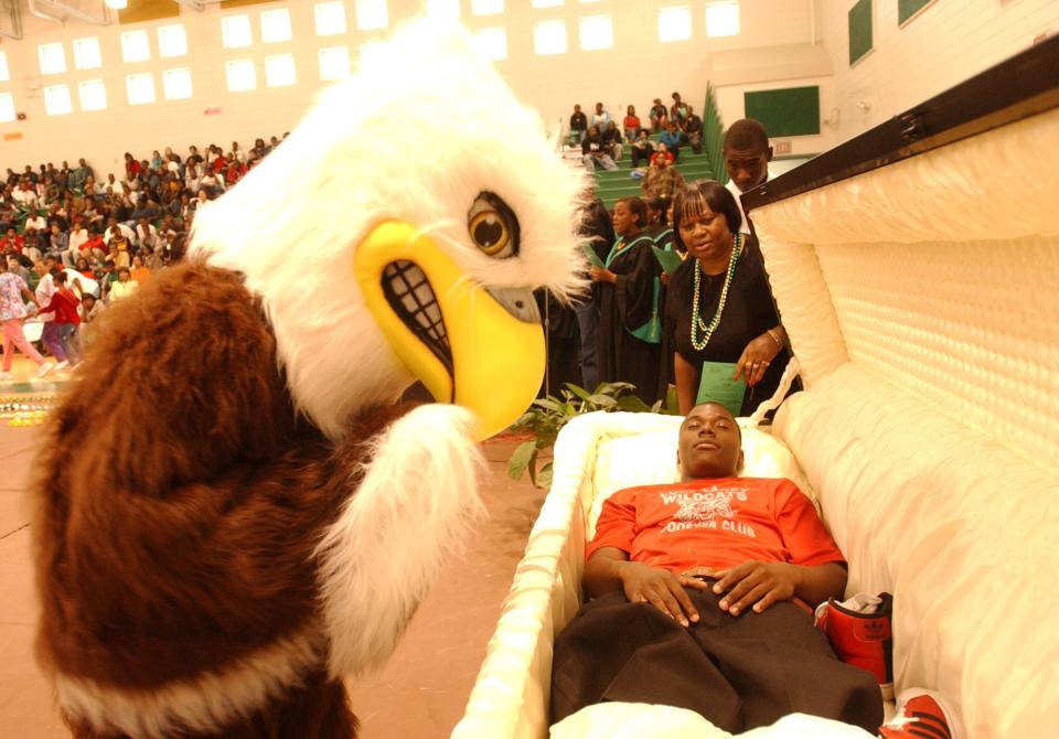 T.W. Josey High School's eagle mascot leans over a Josey student posing as a Wildcat football player during a mock funeral at a Josey pep rally in this 2005 photo. Could eagles be the most popular high school mascot in the state of Georgia?