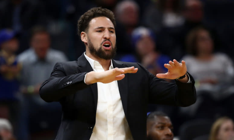 Injured Klay Thompson #11 of the Golden State Warriors reacts on the bench