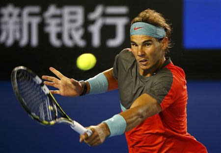 Rafael Nadal of Spain hits a return to Stanislas Wawrinka of Switzerland during their men's singles final match at the Australian Open 2014 tennis tournament in Melbourne January 26, 2014. REUTERS/Petar Kujundzic