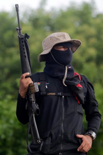 A pro-government Sandinista youth keeps watch as supporters of Nicaragua's President Daniel Ortega celebrate the 39th anniversary of the Sandinista military maneuver "El Repliegue" (The Retreat), in Masaya