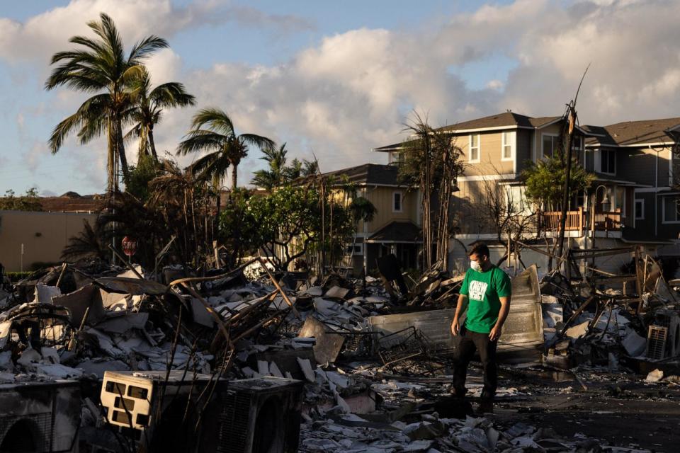 PHOTO: A Mercy Worldwide volunteer makes damage assessment of charred apartment complex in the aftermath of a wildfire in Lahaina, western Maui, Hawaii, Aug. 12, 2023.  (Yuki Iwamura/AFP via Getty Images)