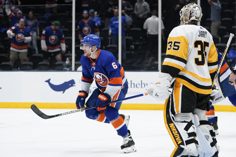 New York Islanders' Ryan Pulock (6) skates toward his bench after scoring a goal as Pittsburgh Penguins goaltender Tristan Jarry (35) watches him during the second period of Game 4 of an NHL hockey Stanley Cup first-round playoff series, Saturday, May 22, 2021, in Uniondale, N.Y. (AP Photo/Frank Franklin II)