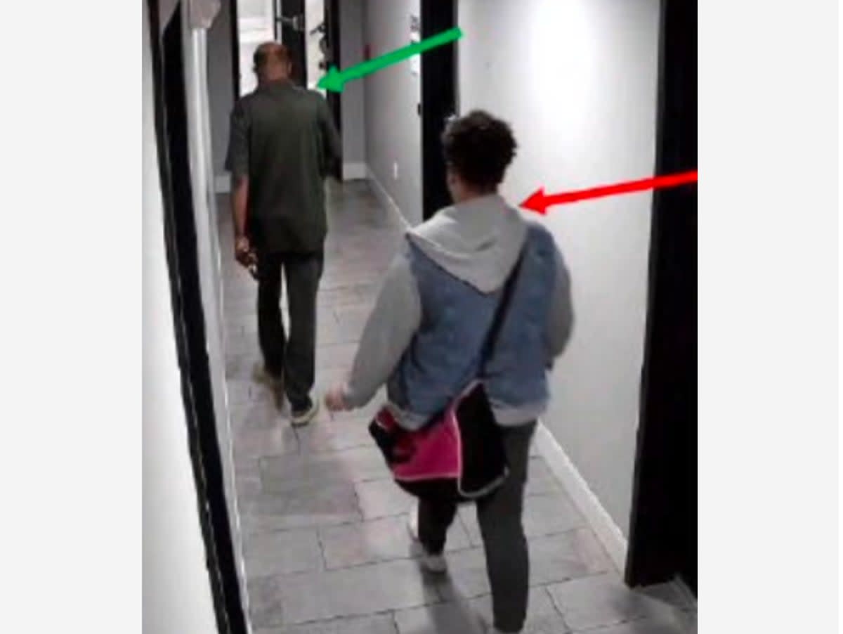 Murder suspect Audrey Miller walking behind the victim, Fasil Teklemariam, toward the elevator in his building on the day he was killed  (DC Superior Court)