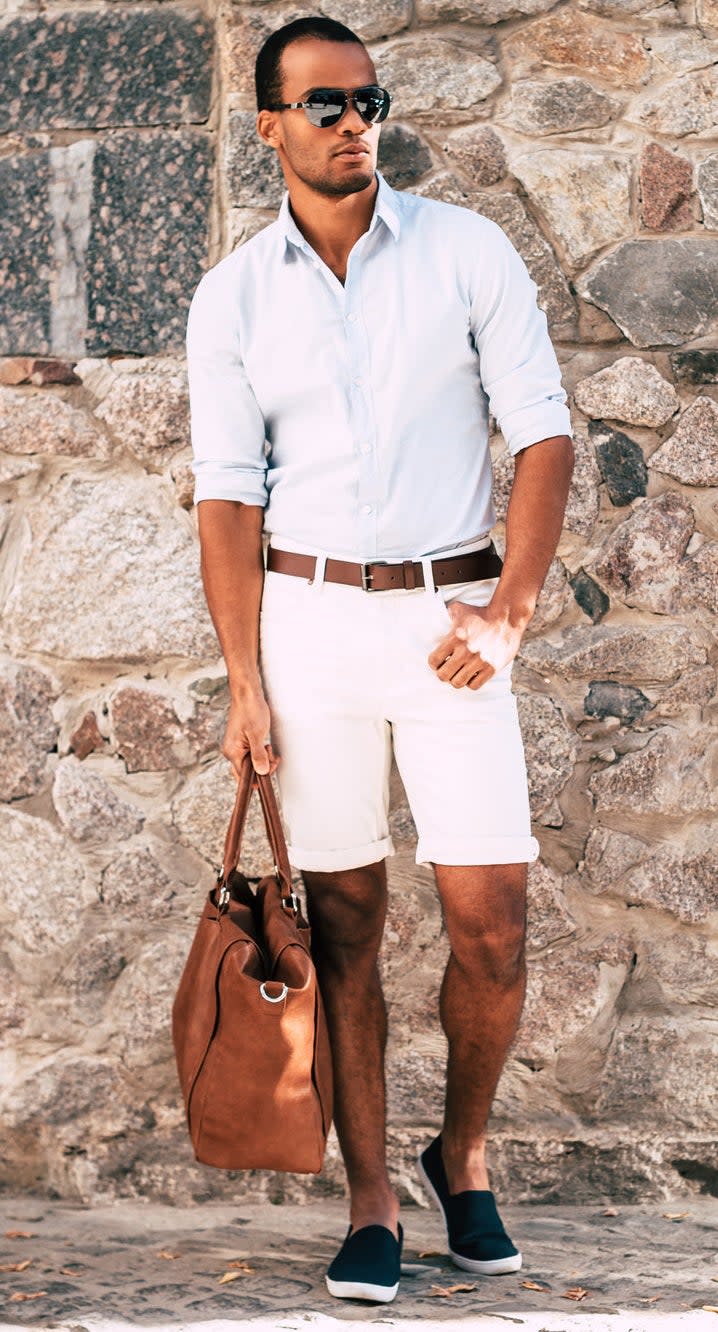 man wearing tight rolled-up shorts, belt, and button-down shirt tucked in