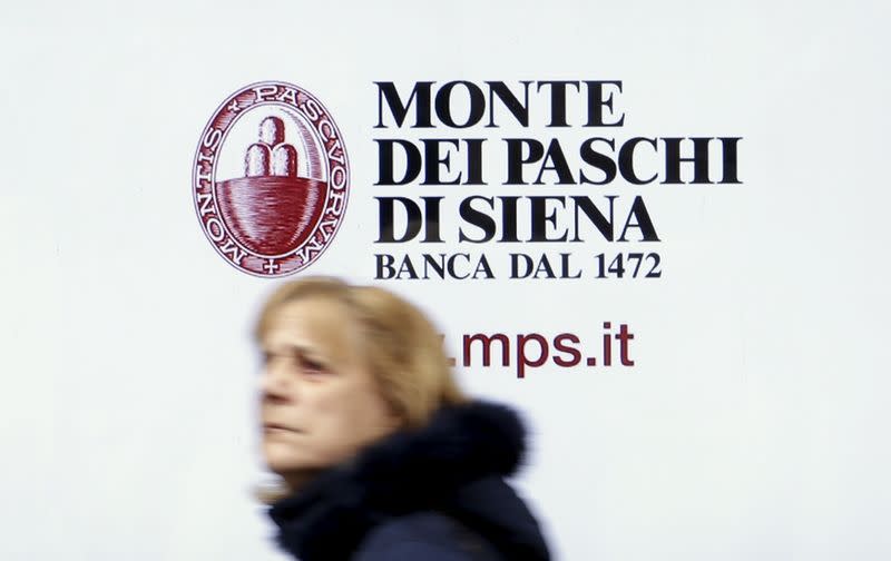 A man walks in front of the Monte dei Paschi bank in Siena