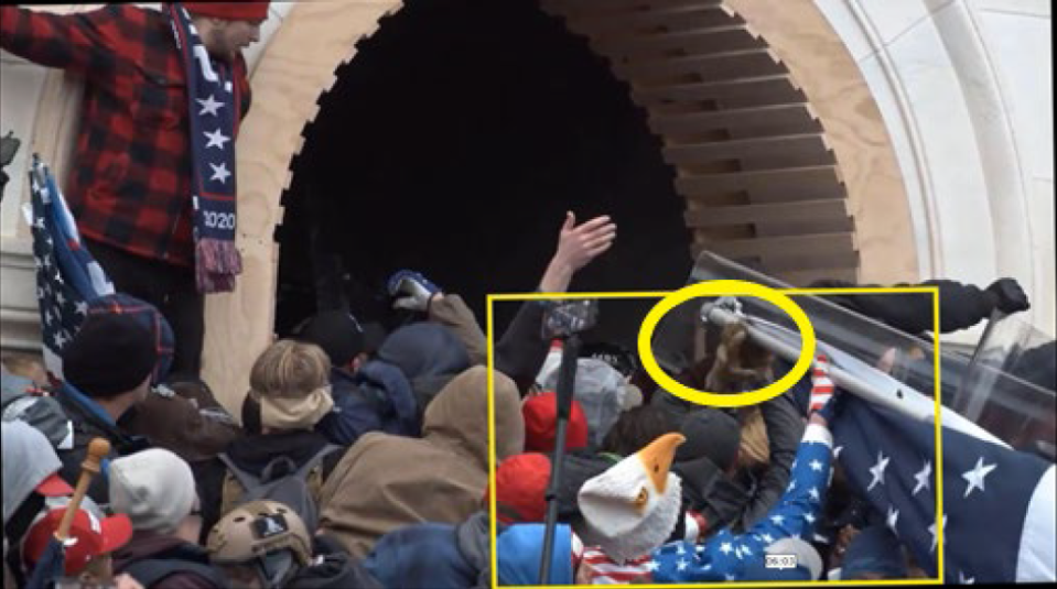 Lewis Easton Cantwell shown in this video still helping propel a flagpole into a tunnel toward officers on Jan. 6 at the Capitol.