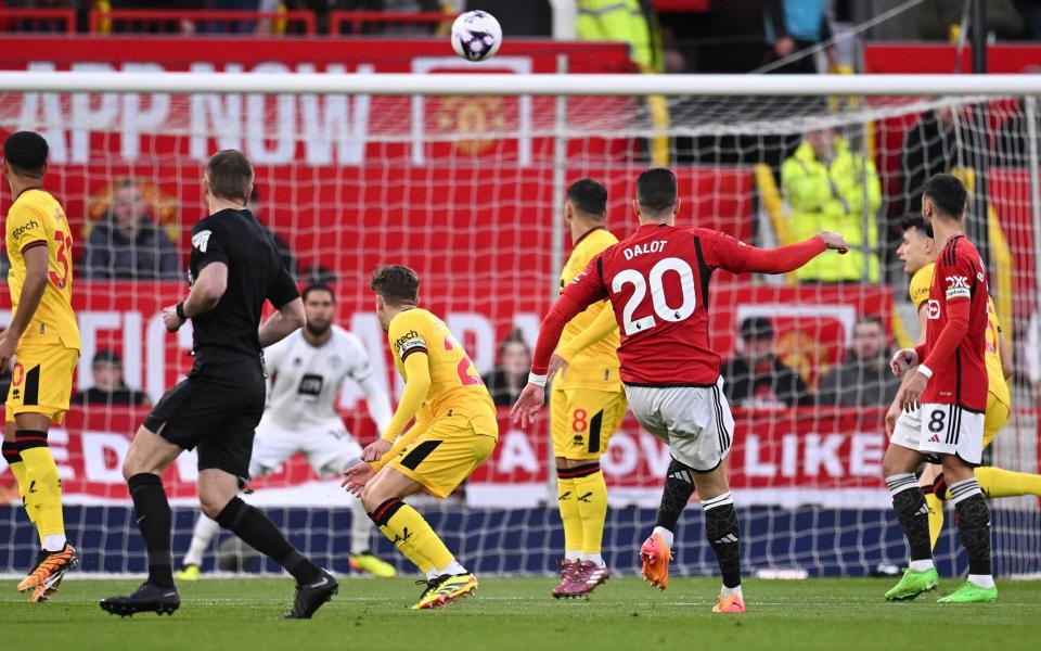 Manchester United's Portuguese defender #20 Diogo Dalot watches as his shot gets saved