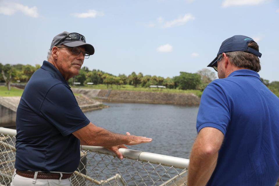 Mark Perry. (left), Florida Oceanographic Society executive director, discusses Lake O discharges with Eric Eikenberg, Everglades Foundation CEO, at the St. Lucie Lock and Dam on Tuesday, July 25, 2023, in Martin County. The purpose of the meeting was to assess the current situation, rally support for the necessary funding to continue progressing with restoration efforts and to discuss the imminent blue-green algae discharges from Lake Okeechobee.