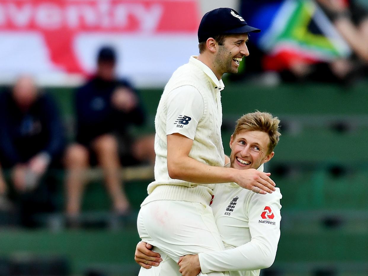 Mark Wood celebrates with Joe Root: Getty