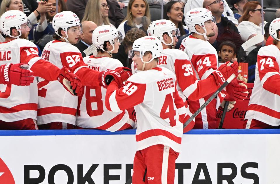 Detroit Red Wings forward Jonatan Berggren (48) celebrates with teammates at the bench after scoring against the Toronto Maple Leafs in the first period at Scotiabank Arena in Toronto on Thursday, Oct. 5, 2023.