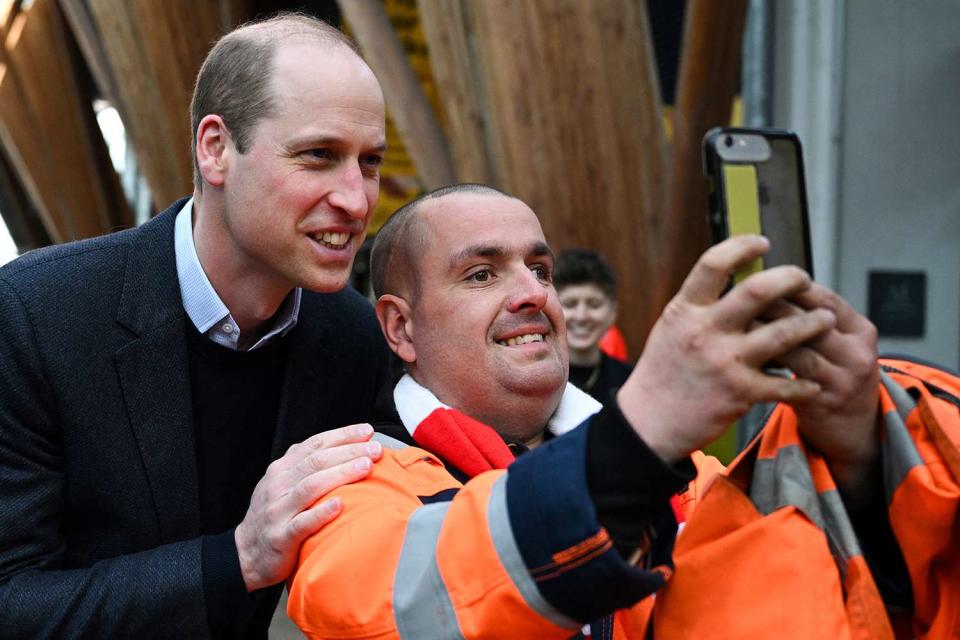 <p>OLI SCARFF/POOL/AFP via Getty Images</p> Prince William and Leigh Stinchcombe smile for a selfie on his way into a Homewards Sheffield Local Coalition meeting in Sheffield on March 19, 2024