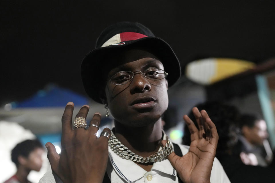 Rapper Real Hoppe poses for a photo at the Gas Battle rapping competition outside a bar in the City of God favela of Rio de Janeiro, Brazil, late Wednesday, Nov. 10, 2021. Rap artists in the favela are starting to compete again since the COVID-19 pandemic curtailed public gatherings, presenting local residents with a show in a sign of a return to normalcy for music lovers. (AP Photo/Silvia Izquierdo)