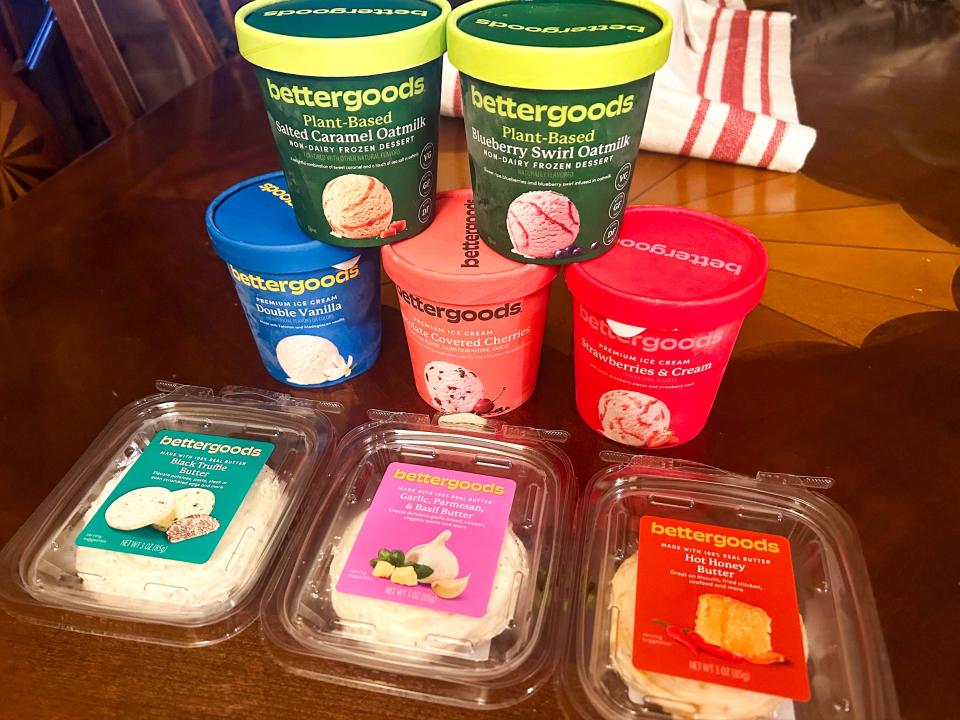 Several Bettergoods products, including colorful frozen dessert and ice cream cartons, and three containers of butter