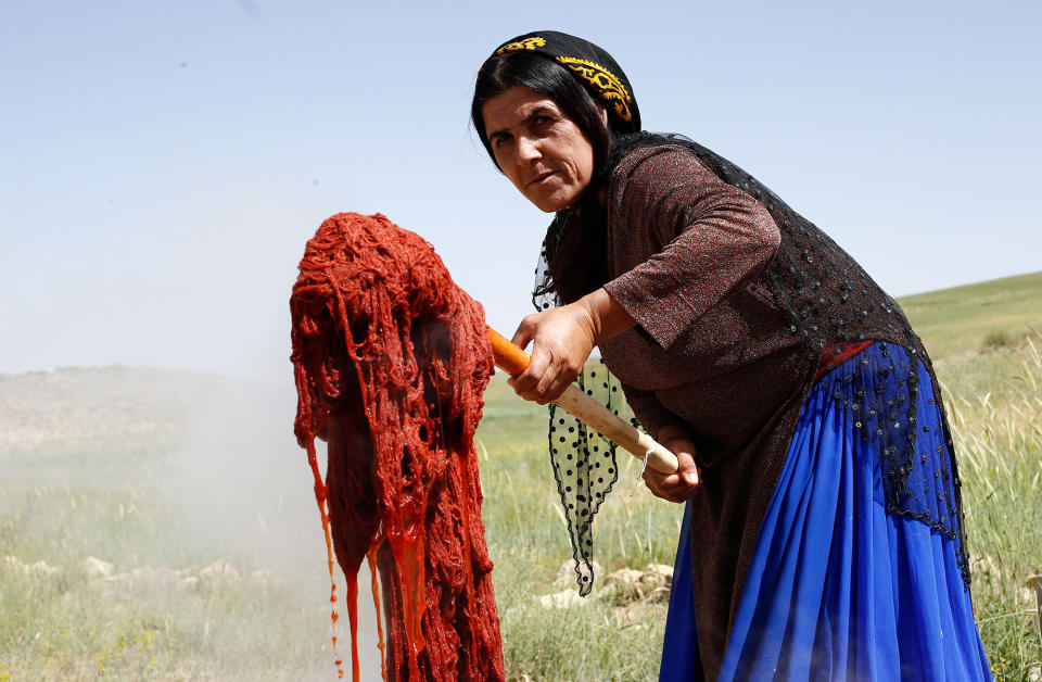 <p>An Iranian Ghashghai nomad woman lift dyed carpet threads to make handmade carpet in the Ghareh Chaman area, outside the city of Shiraz, Fars province, South western Iran, May 22, 2016. Ghashghai tribes are a conglomeration of clans of Turkic ethnic origins as they mainly live in the Iranian province of Fars, especially around the city of Shiraz. Making handmade carpet is one of the old and traditional fashions of the Ghashghai tribes for living as they make the best and famous Fars carpet in the country which Iranian carpet companies buy from them and export to abroad. (ABEDIN TAHERKENAREH/EPA) </p>