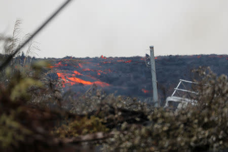 Molten rock from the Kilauea volcano pours down the side of the lava flow on Pohoiki Road near Pahoa, Hawaii, U.S., May 29, 2018. REUTERS/Marco Garcia