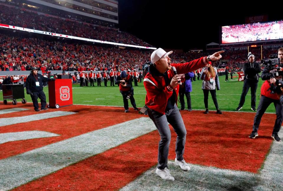 Scotty McCreery leads the crowd in a Wolfpack chant before N.C. State’s game against UNC at Carter-Finley Stadium in Raleigh, N.C., Saturday, Nov. 25, 2023. Ethan Hyman/ehyman@newsobserver.com