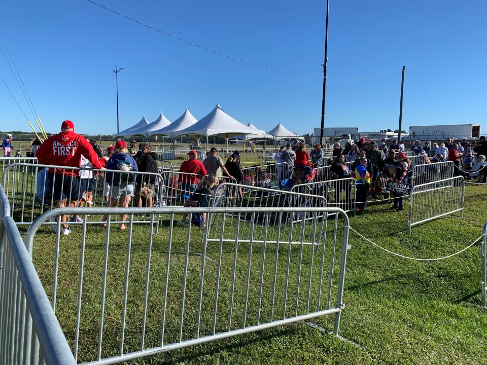 People begin to file to the gate for entry into a rally featuring Donald Trump at the Aero Center near Wilmington International Airport on Friday morning.