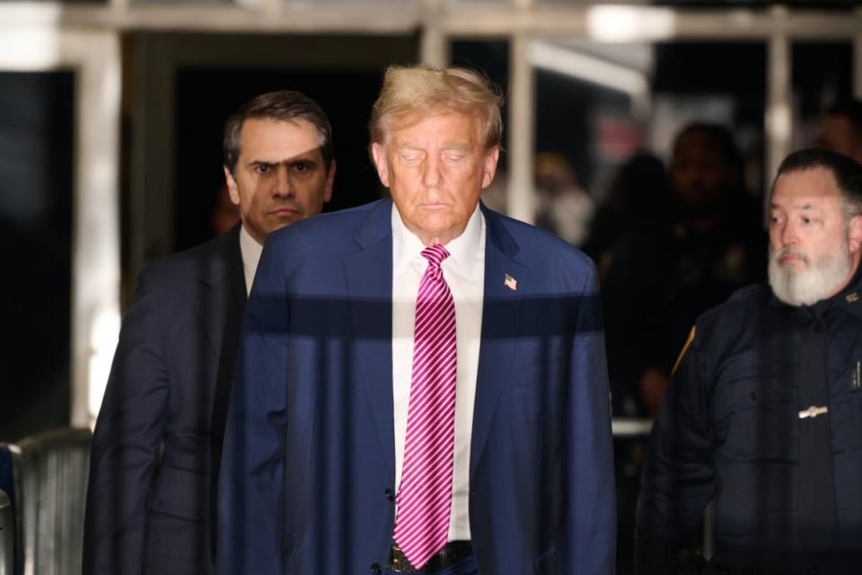 Former president Donald Trump speaks to the media as he exits the courtroom for the day at Manhattan Criminal Court.