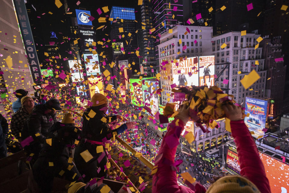 Times Square Alliance volunteers throw confetti during a confetti test as seen from the New York Marriott Marquis during the New Year's Eve celebration in Times Square, Sunday, Dec. 31, 2023, in New York. (AP Photo/Yuki Iwamura)